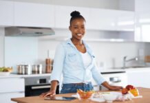 Kitchen Design Made Easy: Tips for Your Dream Space! Smiling woman cooking in a modern kitchen
