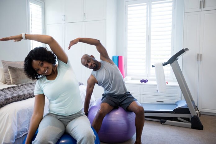 Two people exercising in a home gym.